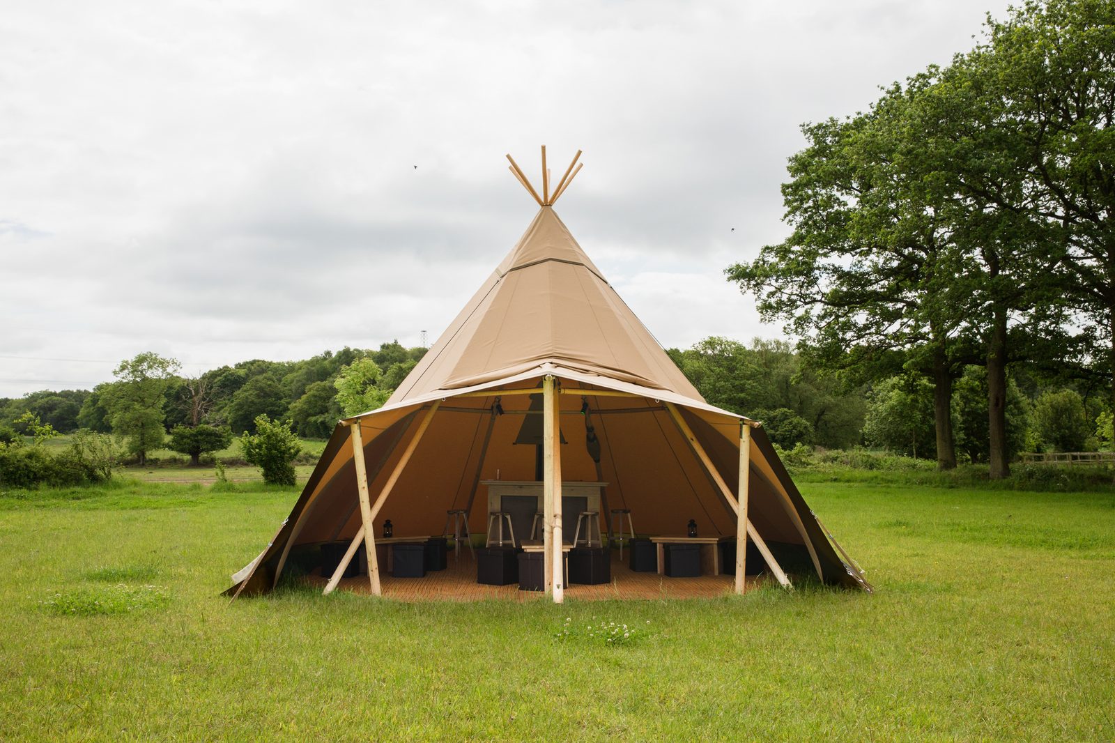 A Beehive Cirrus 28 tipi with porch in a Yorkshire meadow surrounded by trees