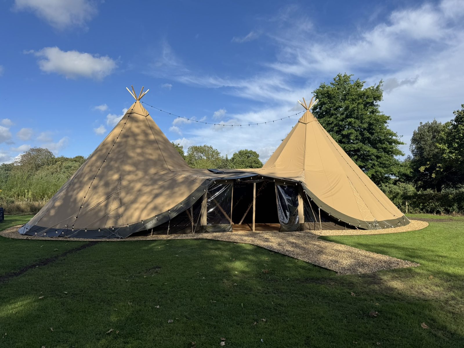 The linked twin tipi classroom at Cransley School in early autumn sunshine