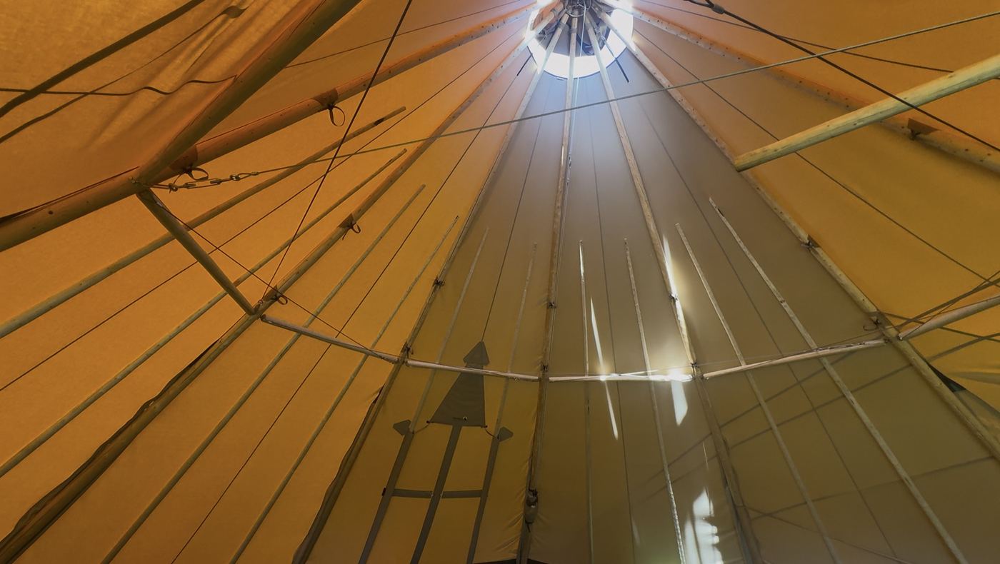 Looking up inside the Cransley School tipi at the canvas canopy and crown