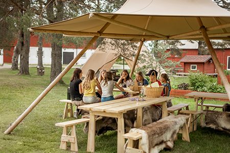 Children gathered under a Beehive Nimbus 16 forest school shelter — South West forest school heartland