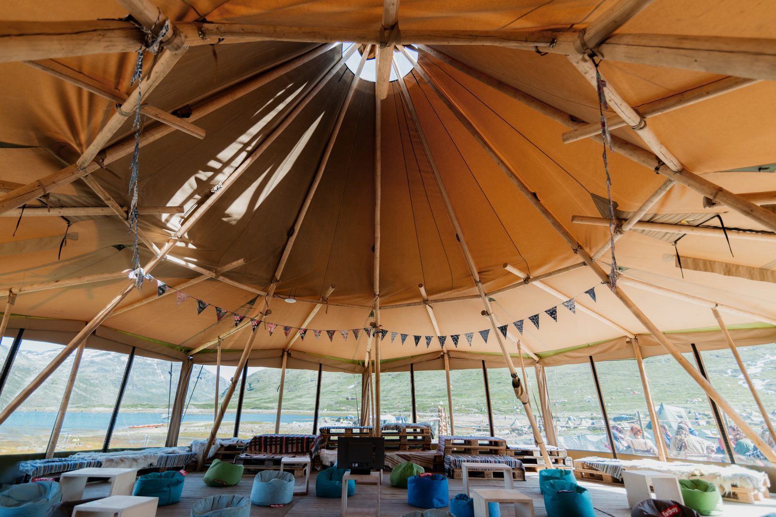 Inside a Beehive Stratus 72 tipi with WallFlex windows looking out onto the landscape — East of England